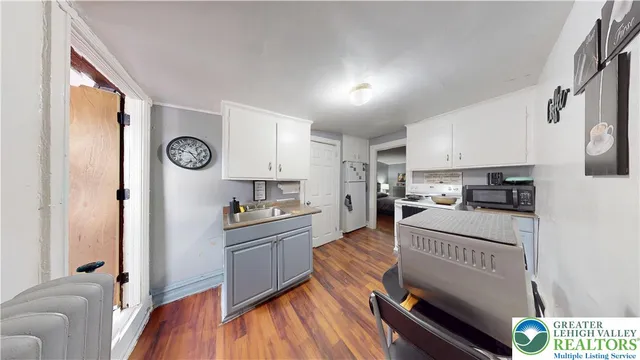 a kitchen with a refrigerator and a stove