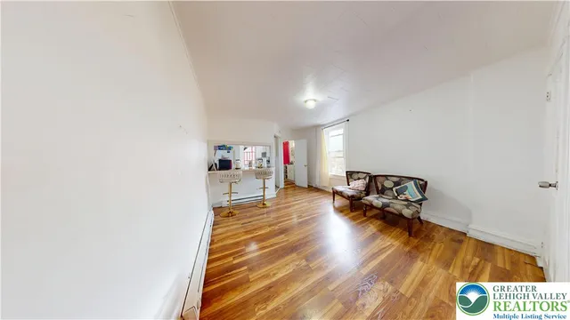 a bedroom with furniture and a wooden floor