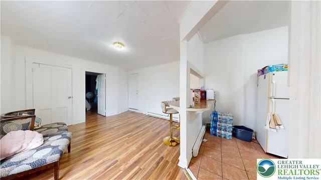 a bedroom with a bed and a flat tv screen on dresser