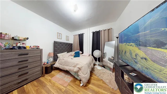 a bed room with a bed and a flat screen tv