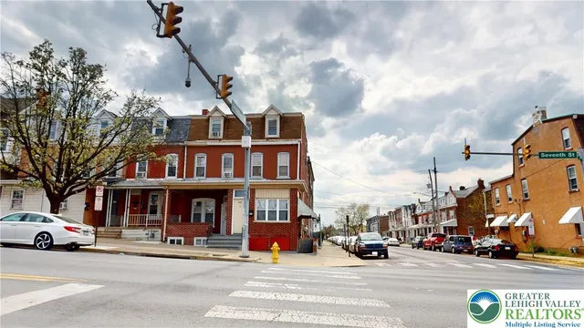 a view of a street that has couple of cars parked on the road