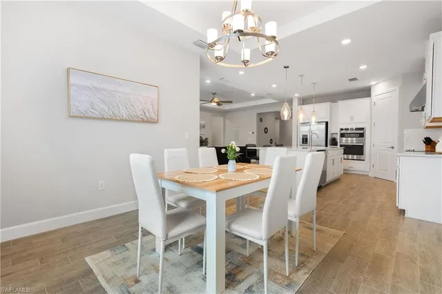 a view of a dining room with furniture and chandelier