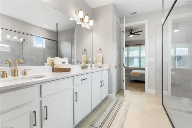 a en suite bathroom with a double sink and mirror