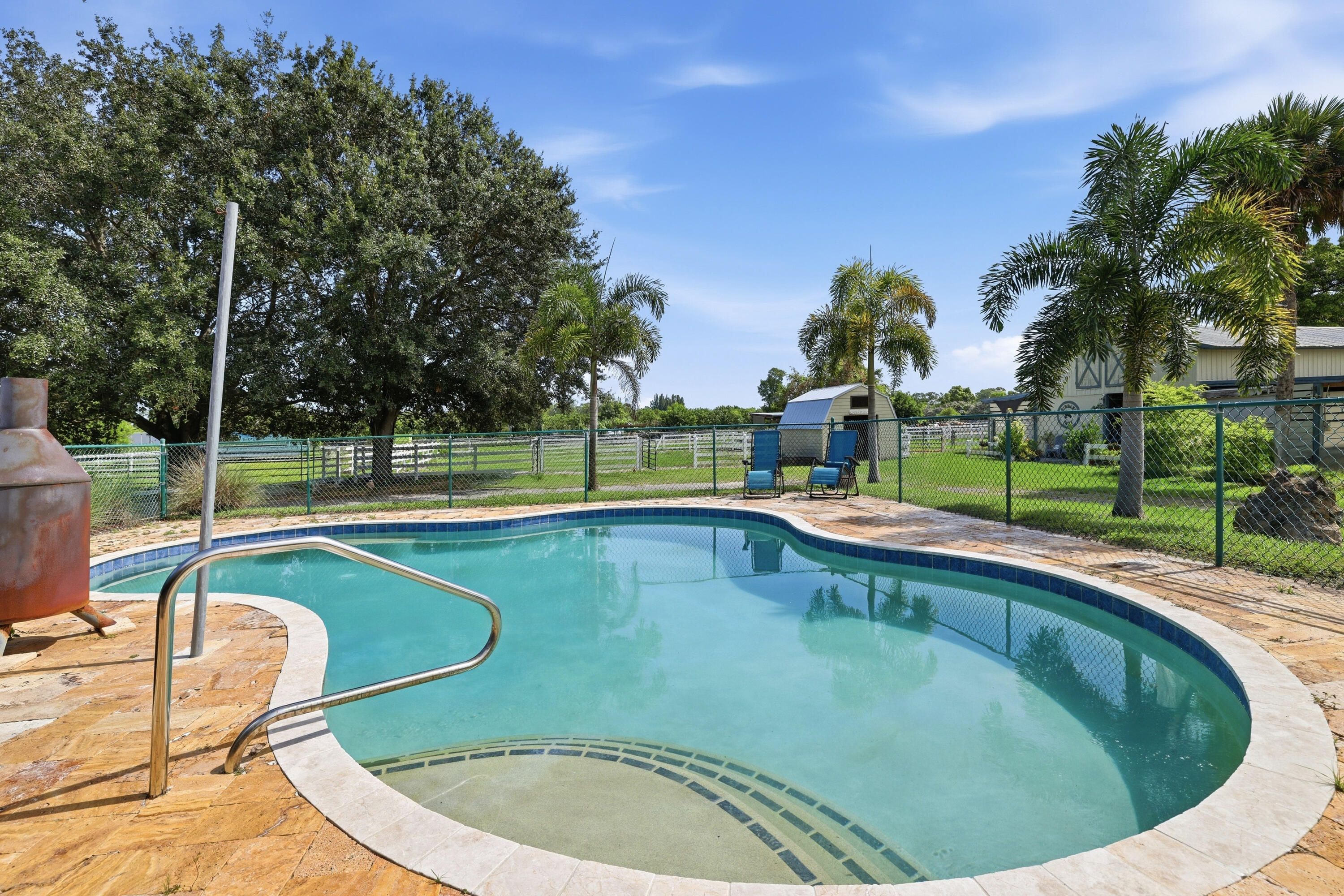 14095 Biddex Road Loxahatchee Groves, FL 33470 - Photo 31 of 69 a view of a swimming pool with a patio