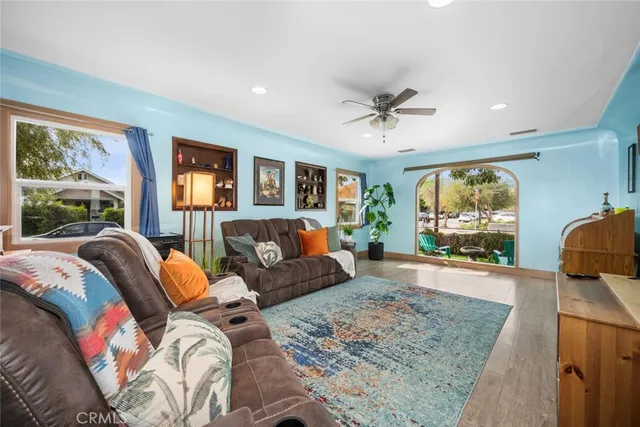 a bedroom with furniture and a large window