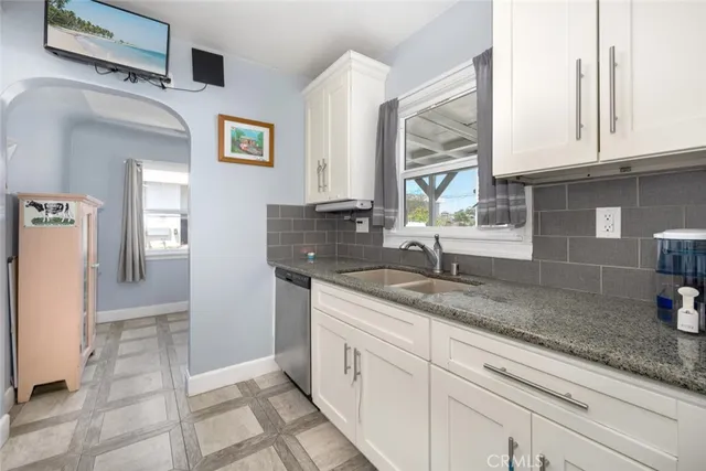 a kitchen with stainless steel appliances granite countertop a sink and cabinets