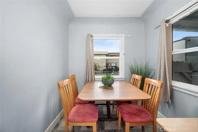 a view of a dining room with a table and chairs