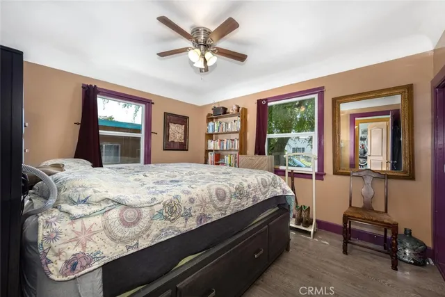 a bed sitting in a spacious bedroom next to a window