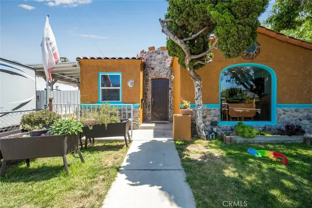 a front view of a house with a garden