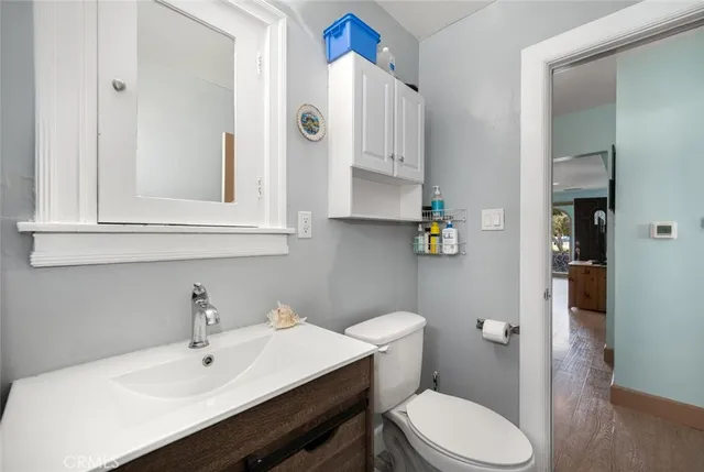 a bathroom with a sink mirror and toilet