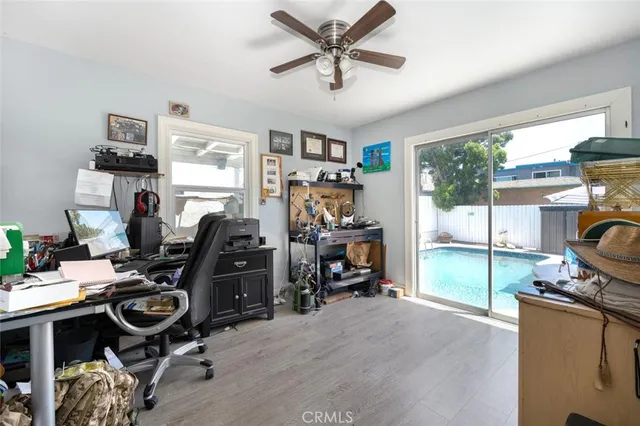 a view of a workspace with furniture and a window