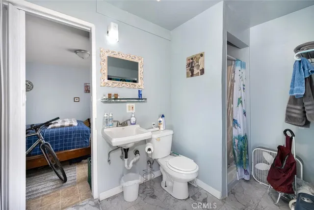 a bathroom with a toilet a sink and mirror