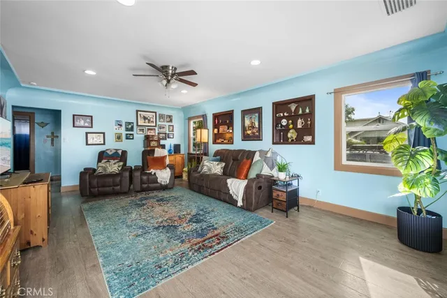 a living room with furniture and a potted plant