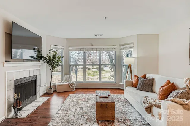 a living room with furniture and a fireplace
