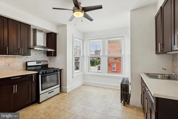 a kitchen with stainless steel appliances granite countertop a stove and a sink