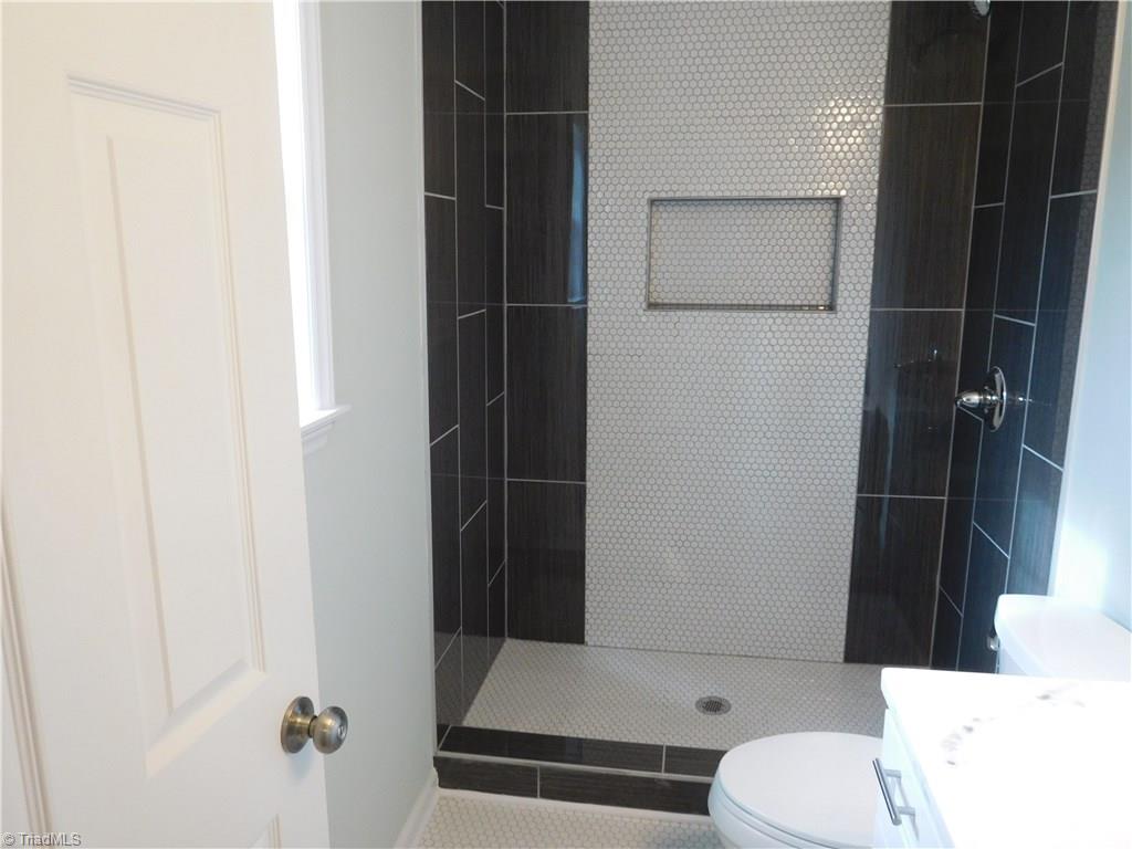 144 Hauser Road Lewisville, NC 27023 - Photo 10 of 21 Beautifully tiled Master Bathroom. Walk-in Tiled Shower, tiled floor & Granite top Vanity.
