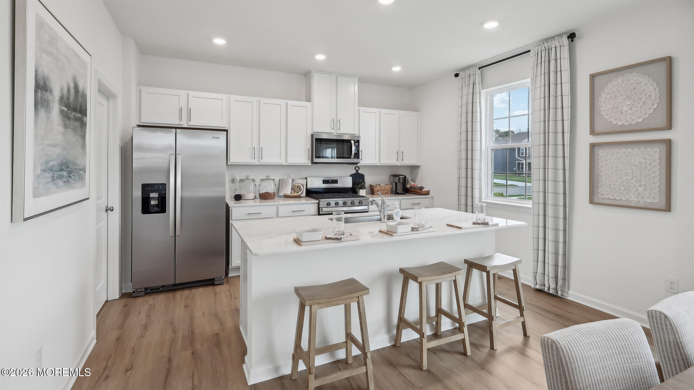 445 Ridge Avenue Hamilton, NJ 08610 - Photo 14 of 33 a kitchen with stainless steel appliances granite countertop a refrigerator a stove a sink a dining table and chairs