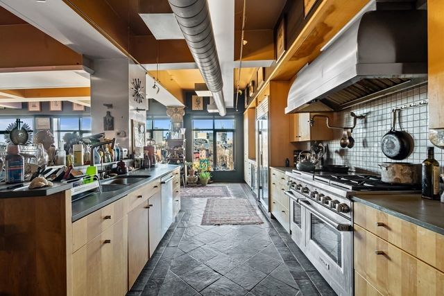 a kitchen with stainless steel appliances granite countertop a stove and a sink