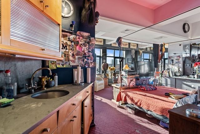 a kitchen with stainless steel appliances kitchen island granite countertop a sink stove and cabinets