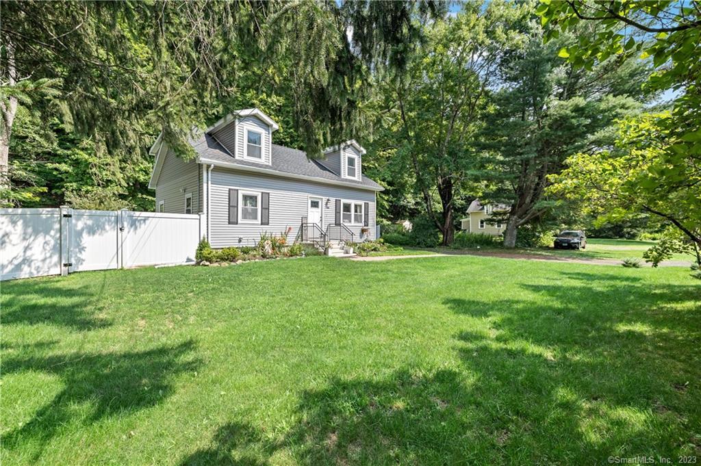 66 Bee Brook Road Washington, CT 06794 - Photo 1 of 1 a front view of house with yard and green space