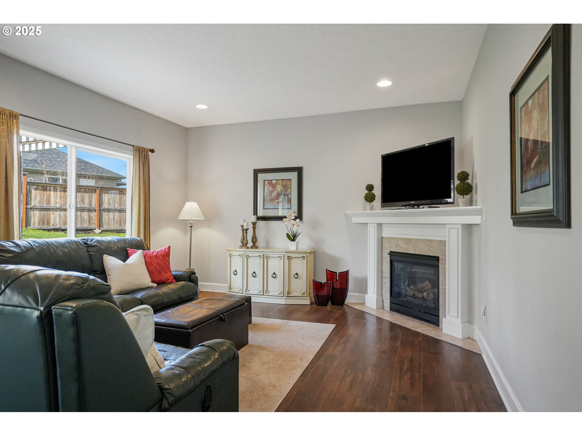1832 Northwest Olivia Circle Albany, OR 97321 - Photo 22 of 48 a living room with furniture a fireplace and a flat screen tv