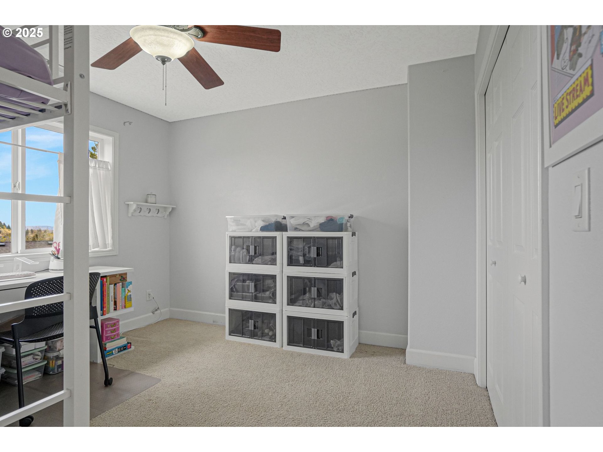1832 Northwest Olivia Circle Albany, OR 97321 - Photo 35 of 48 a view of a bedroom with a cabinet and a ceiling fan