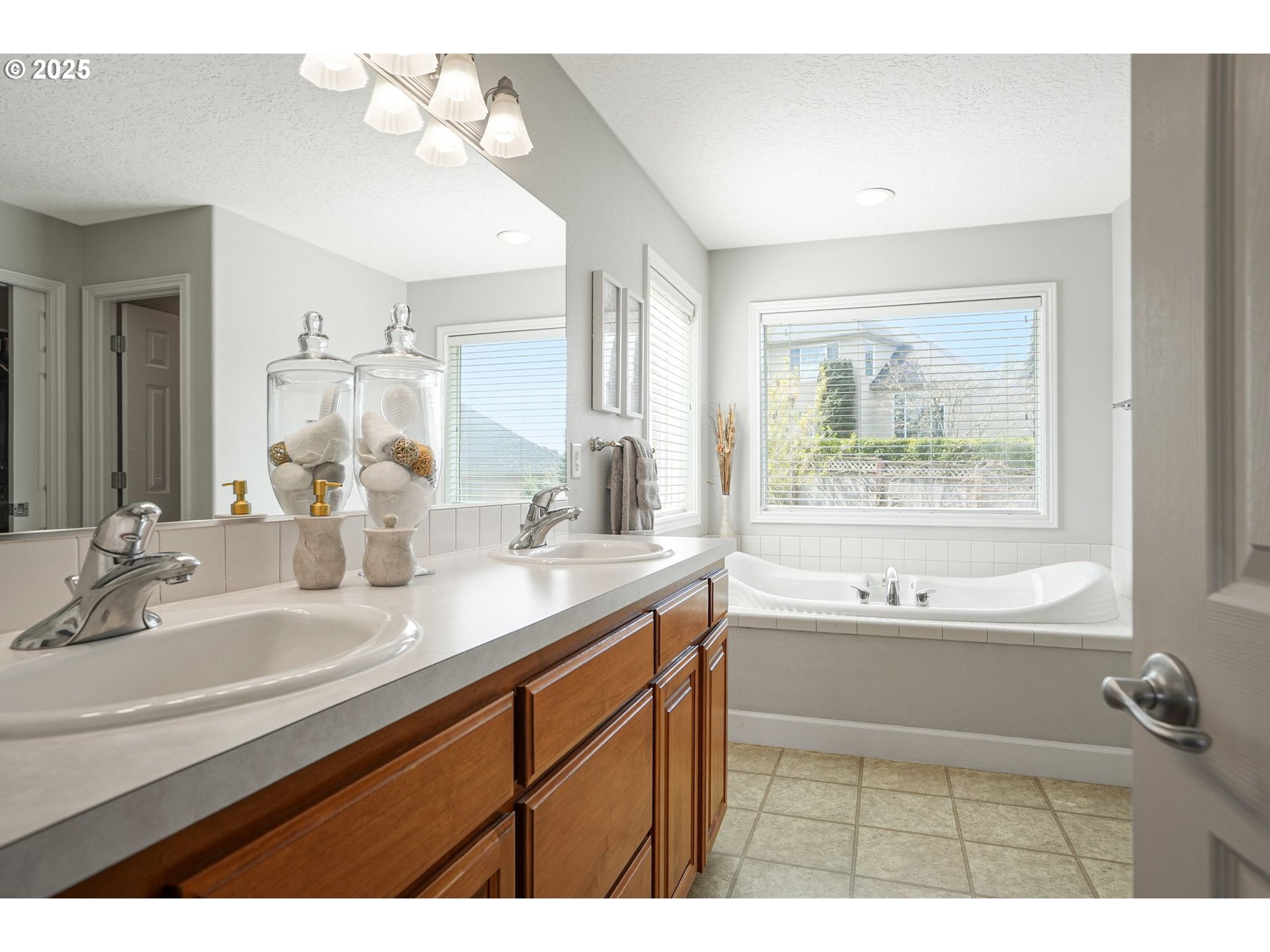 1832 Northwest Olivia Circle Albany, OR 97321 - Photo 44 of 48 a bathroom with a tub a sink and a large mirror
