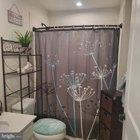 a bathroom with a toilet a sink and tub