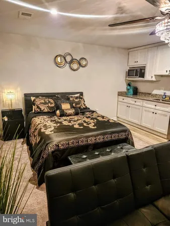 a bed sitting in a bedroom next to a window