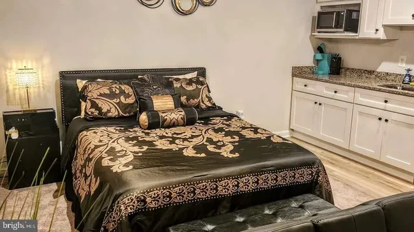 a bed sitting in a bedroom next to a window