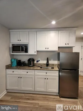 a kitchen with stainless steel appliances granite countertop a refrigerator sink and cabinets