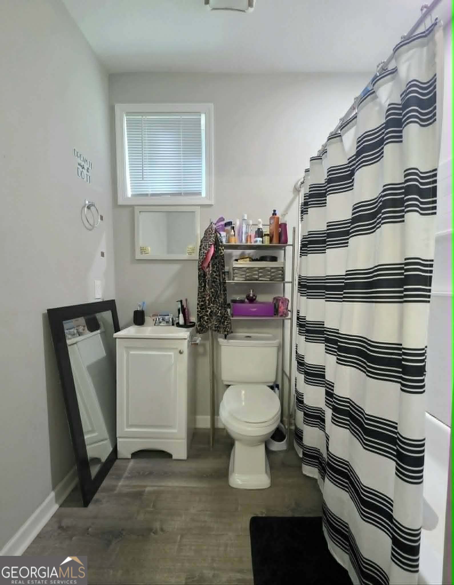 119 O Street Southwest Thomaston, GA 30286 - Photo 8 of 9 a bathroom with a sink toilet and a mirror