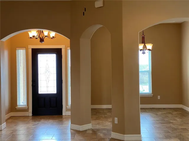 an empty room with wooden floor and a window