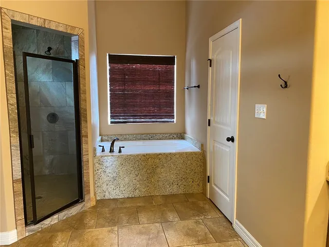 a view of a bathroom with a tub shower and sink