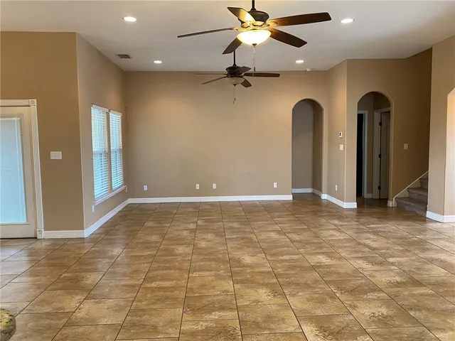 a view of an empty room with a ceiling fan