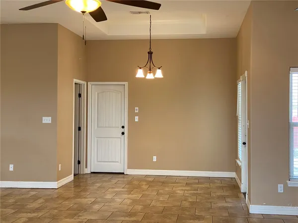 a view of a livingroom with a chandelier fan and entryway