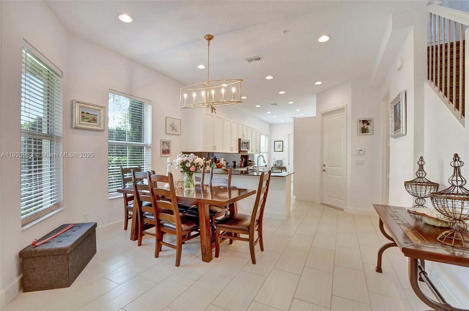 6657 Quiet Wave Trail, Unit 100 Boca Raton, FL 33433 - Photo 13 of 40 a view of a dining room with furniture and chandelier