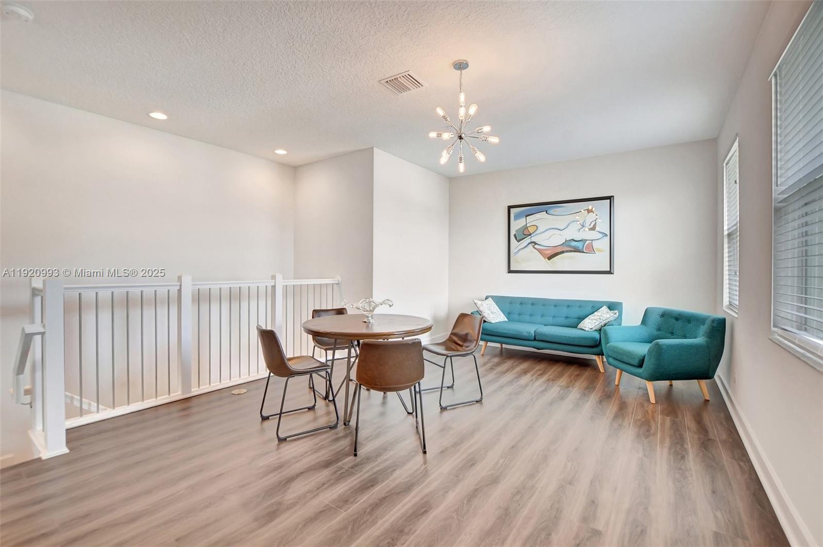 6657 Quiet Wave Trail, Unit 100 Boca Raton, FL 33433 - Photo 16 of 40 a view of a dining room with furniture window and wooden floor