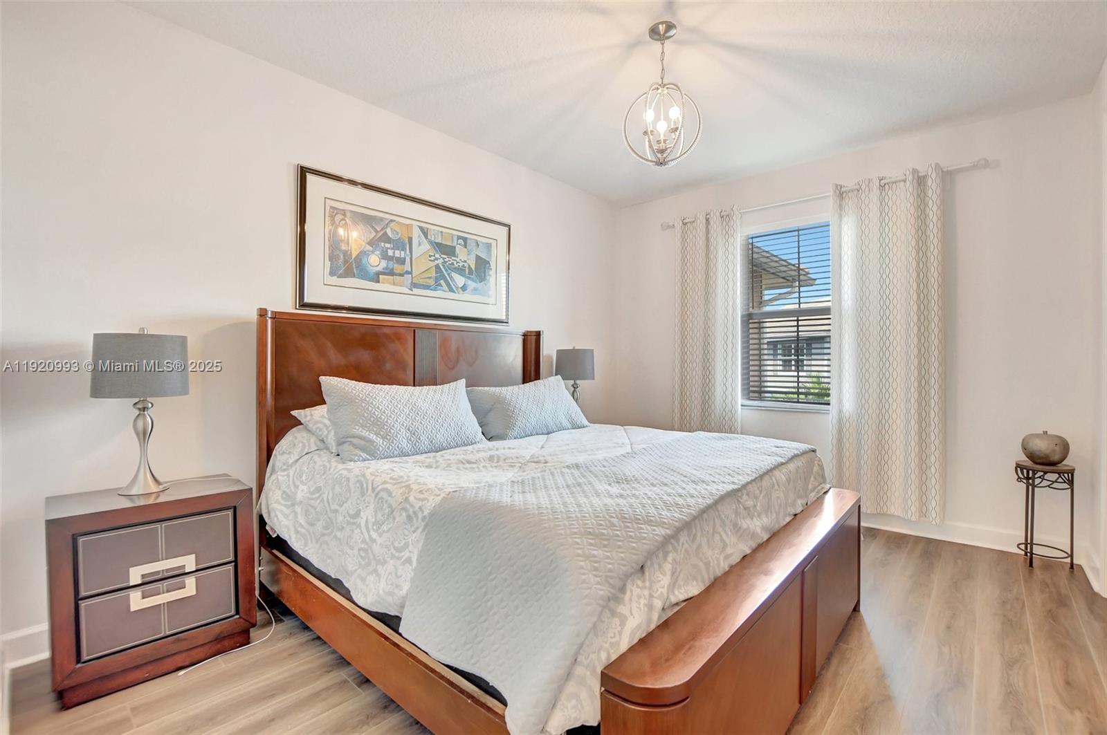 6657 Quiet Wave Trail, Unit 100 Boca Raton, FL 33433 - Photo 18 of 40 a bedroom with a bed and a window