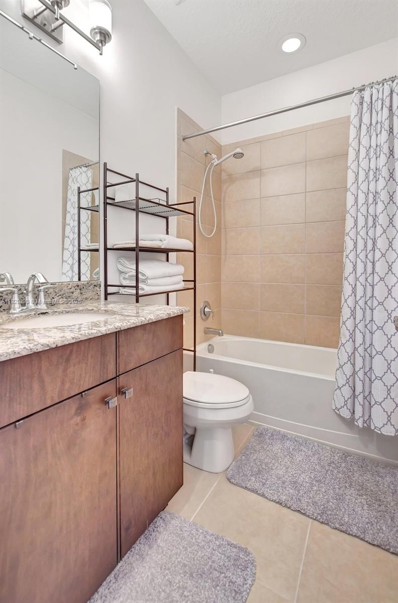 6657 Quiet Wave Trail, Unit 100 Boca Raton, FL 33433 - Photo 23 of 40 a bathroom with a granite countertop bathtub shower sink vanity and toilet