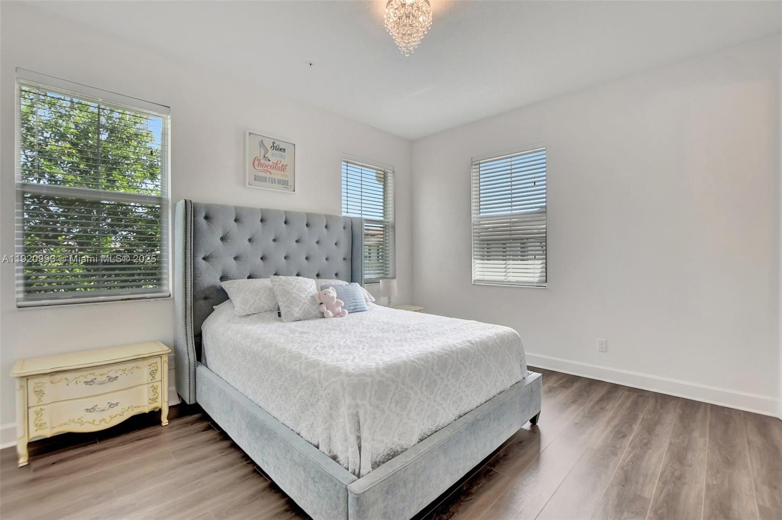 6657 Quiet Wave Trail, Unit 100 Boca Raton, FL 33433 - Photo 25 of 40 a bedroom with a bed and window