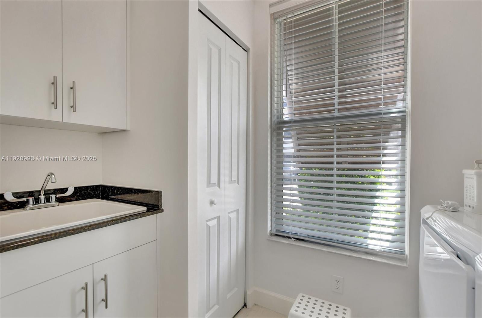 6657 Quiet Wave Trail, Unit 100 Boca Raton, FL 33433 - Photo 26 of 40 a kitchen with a sink and cabinets