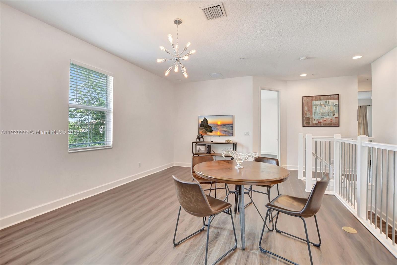 6657 Quiet Wave Trail, Unit 100 Boca Raton, FL 33433 - Photo 28 of 40 a dining room with wooden floor and breakfast area