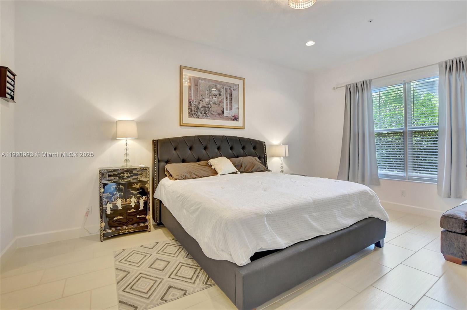 6657 Quiet Wave Trail, Unit 100 Boca Raton, FL 33433 - Photo 31 of 40 a bedroom with a bed and a window