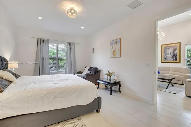 a bedroom with a bed couch and a window