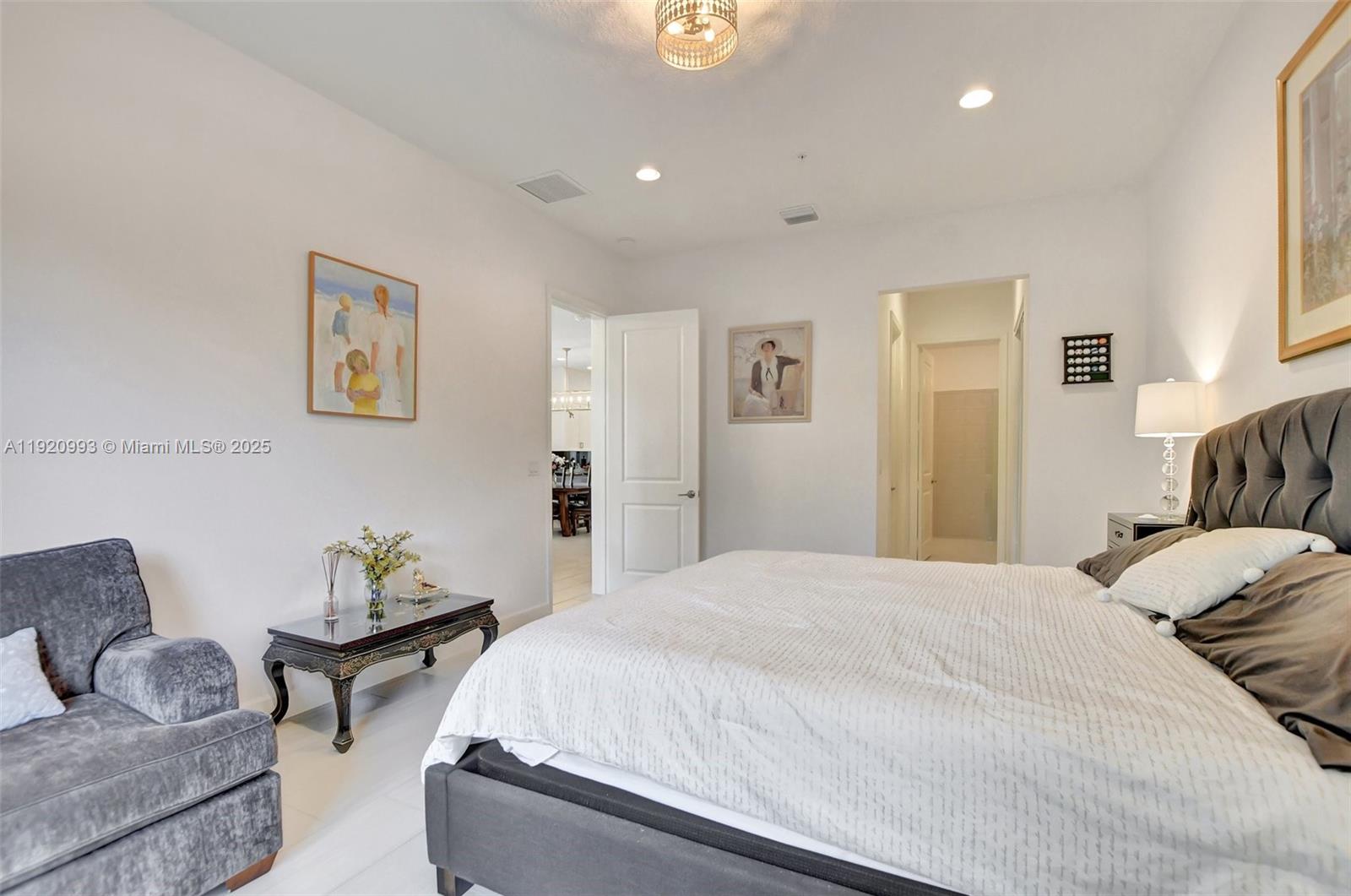 6657 Quiet Wave Trail, Unit 100 Boca Raton, FL 33433 - Photo 33 of 40 a bedroom with a bed couch and a window