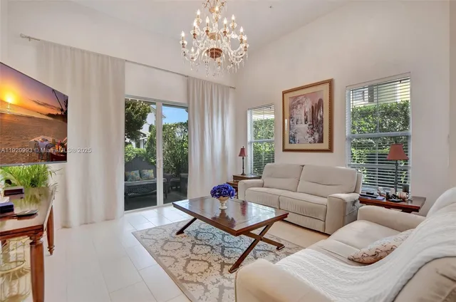 a living room with furniture and a chandelier