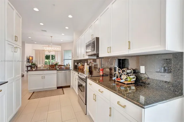 a view of a kitchen with furniture and a refrigerator