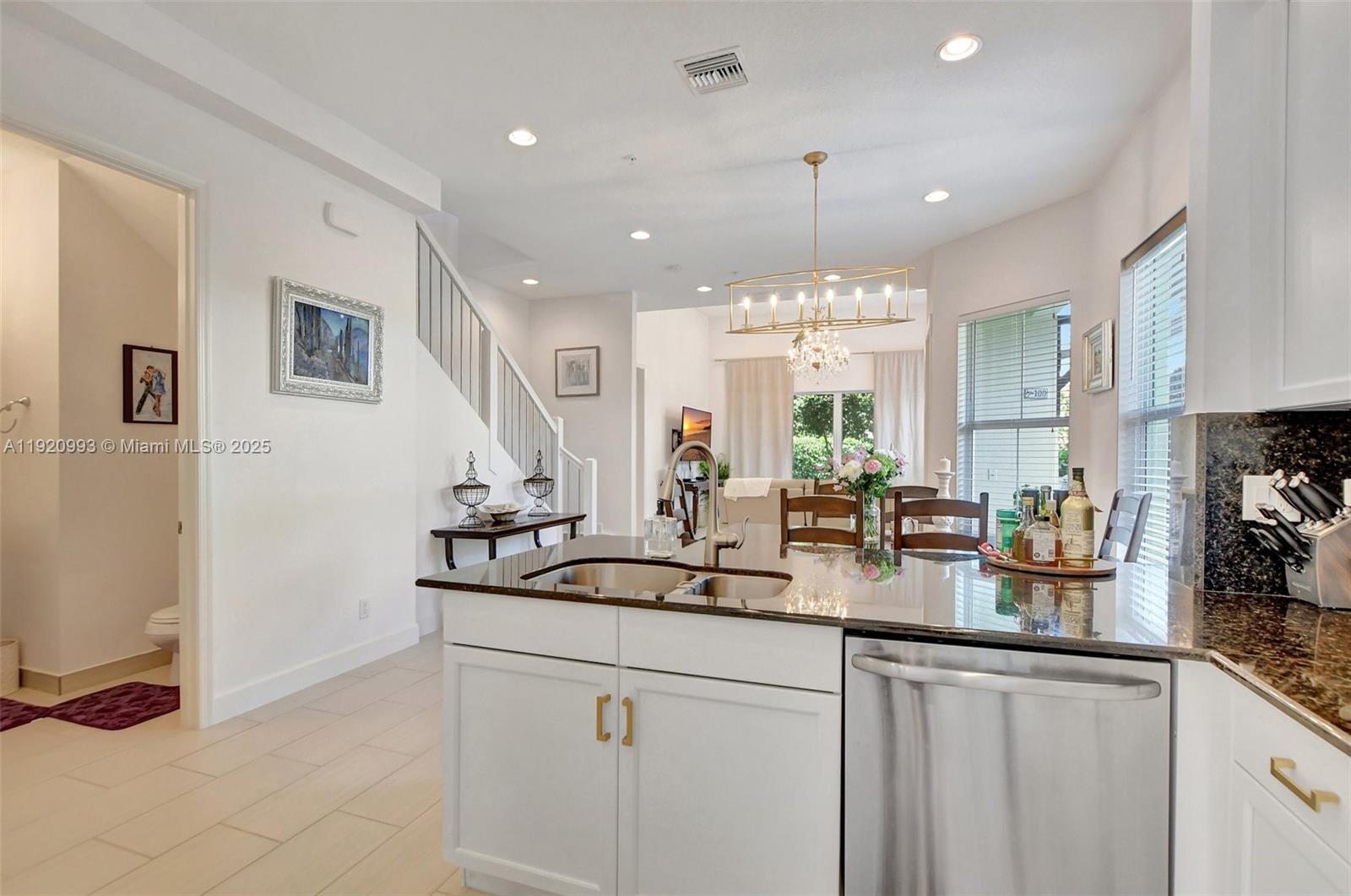 6657 Quiet Wave Trail, Unit 100 Boca Raton, FL 33433 - Photo 10 of 40 a kitchen with counter top space and appliances