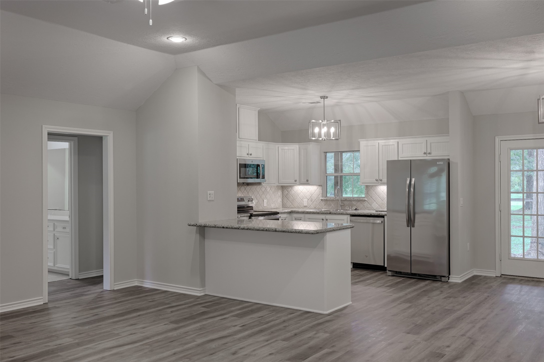 3131 Sapp Road Conroe, TX 77304 - Photo 13 of 48 a kitchen with stainless steel appliances granite countertop a stove and a refrigerator